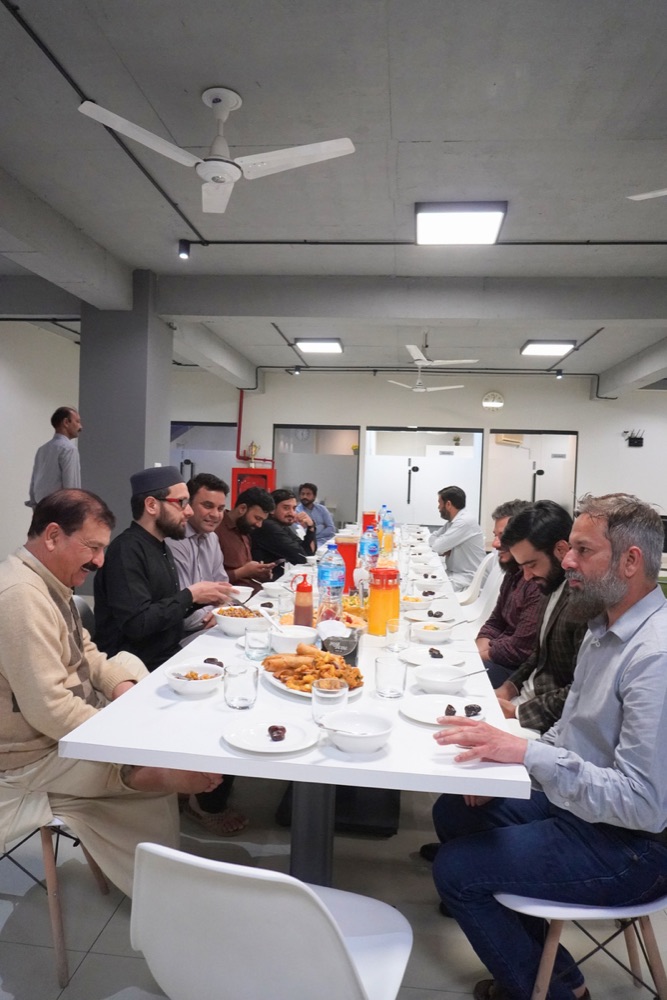 Zeropoint team members sharing an Iftar meal at a long table