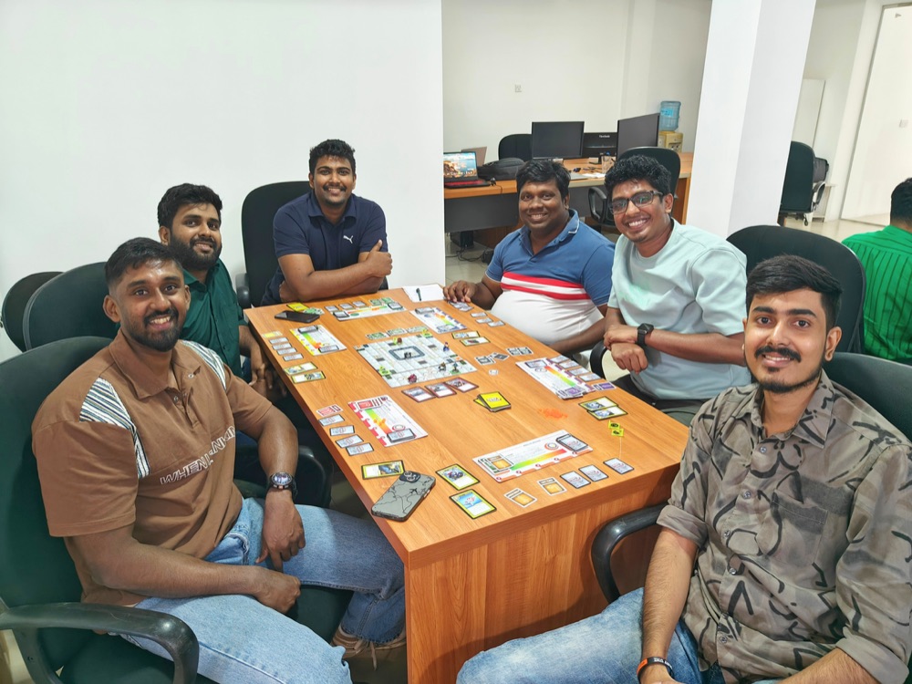 Zeropoint colleagues playing a board game together during game night in Colombo